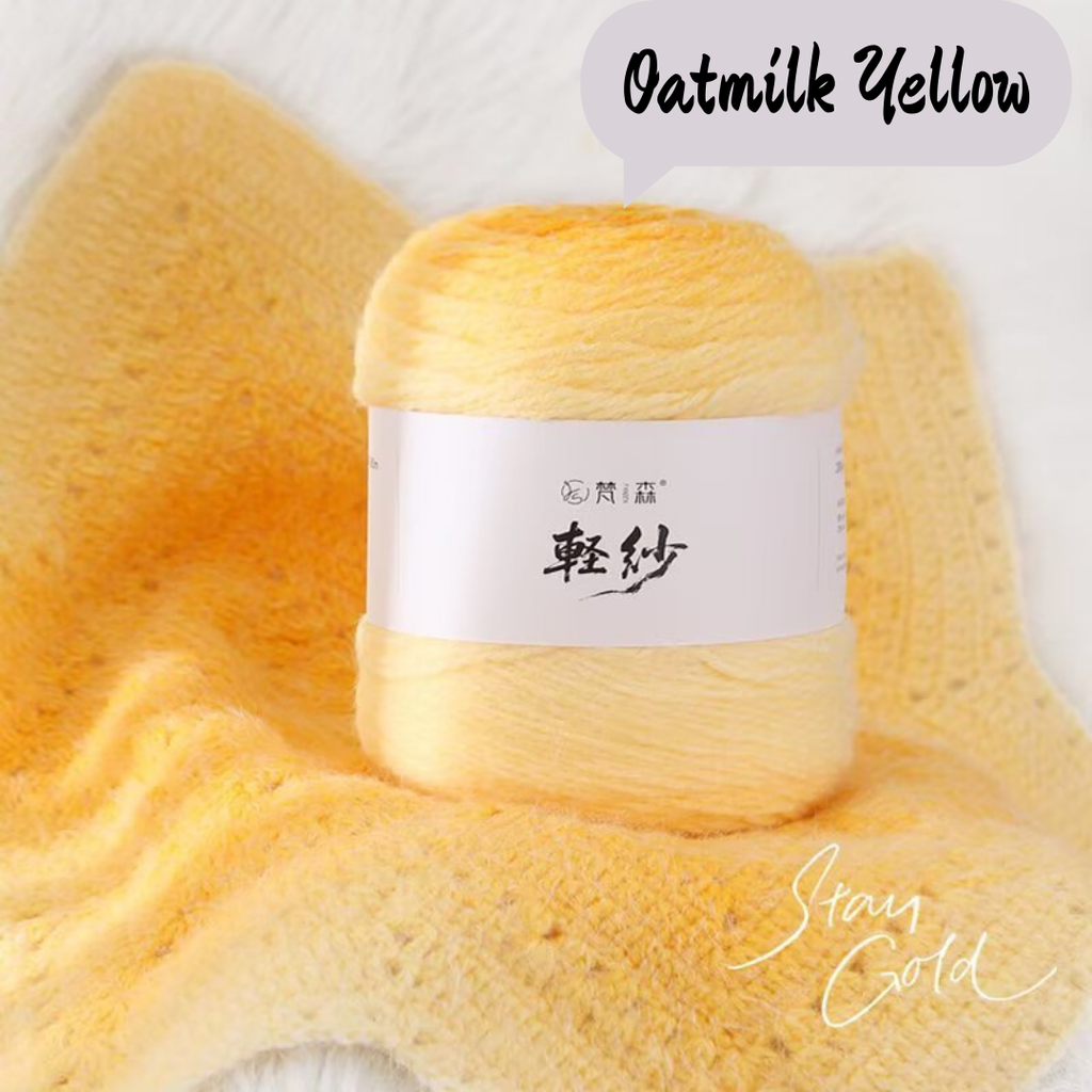 Ball of oatmilk yellow yarn with a label on a matching fabric background