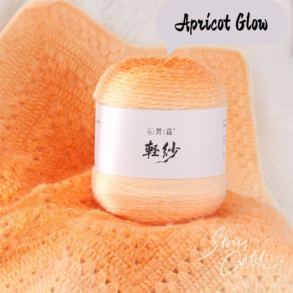 Ball of yarn labeled 'Apricot Glow' on a matching fabric background