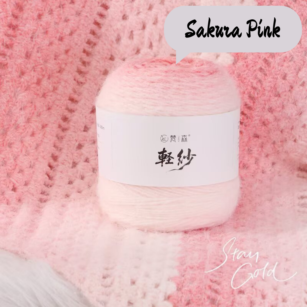Ball of yarn with a label on a pink textured background