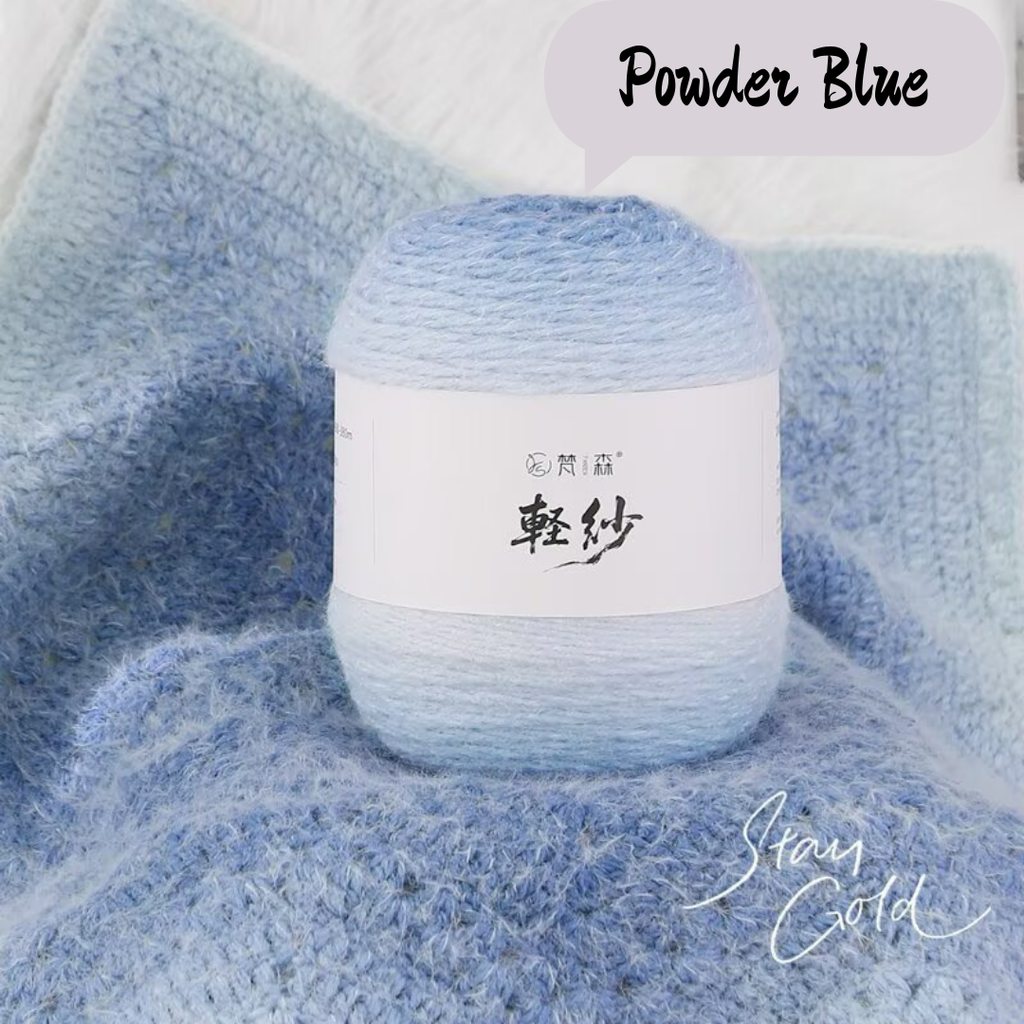 Ball of yarn with a label on a blue textured fabric background