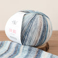 Ball of yarn with a patterned design on a wooden surface