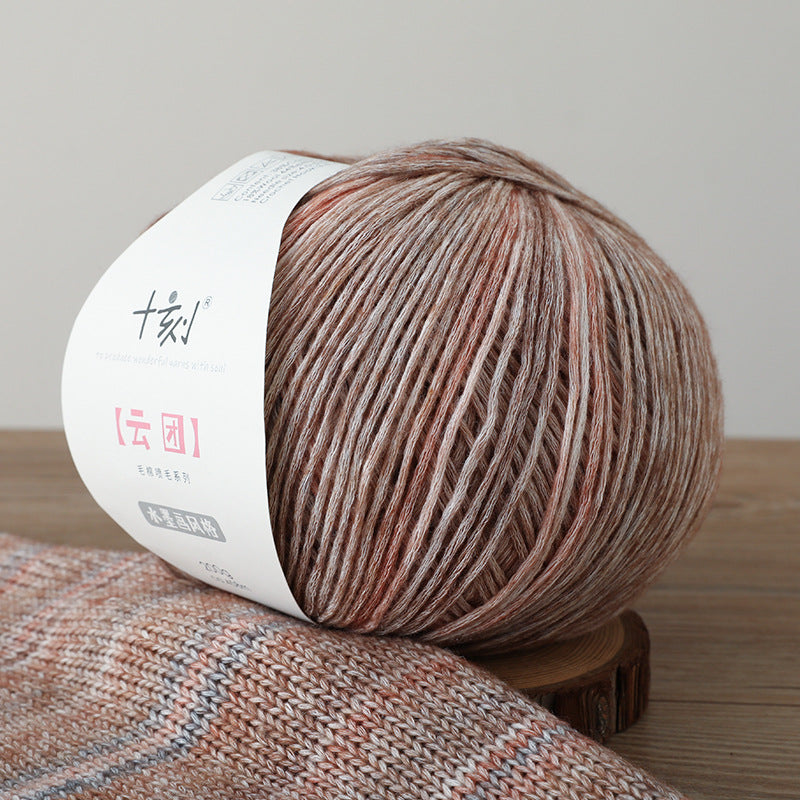 Ball of yarn with a label on a wooden surface