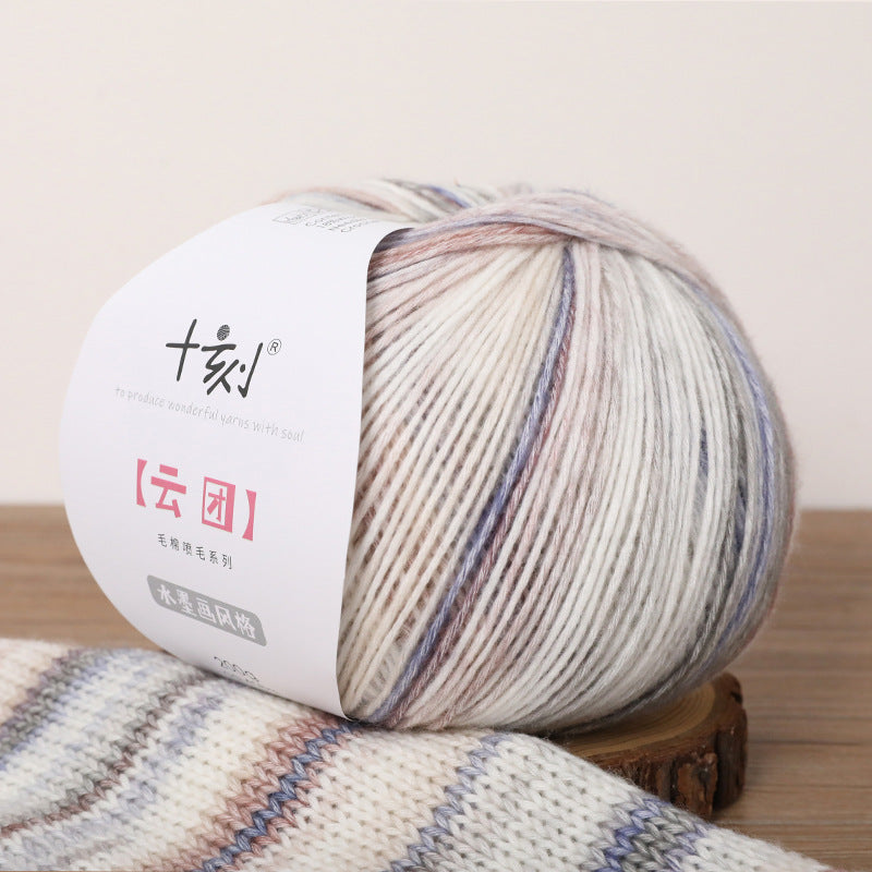 Multicolored yarn ball with a label on a wooden surface