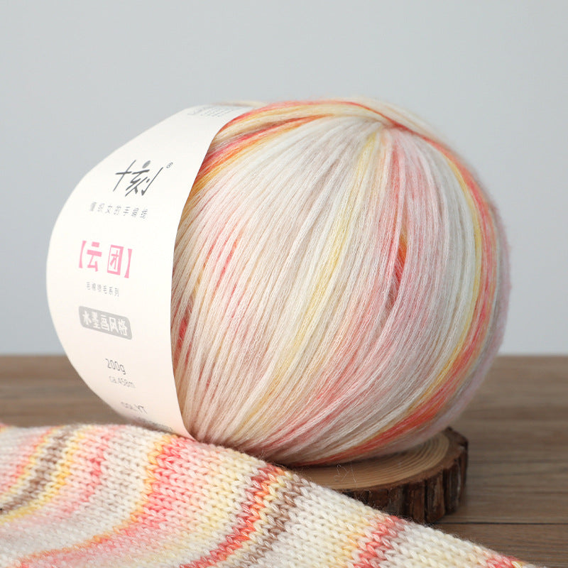 Ball of yarn with a gradient of colors on a wooden stand against a neutral background