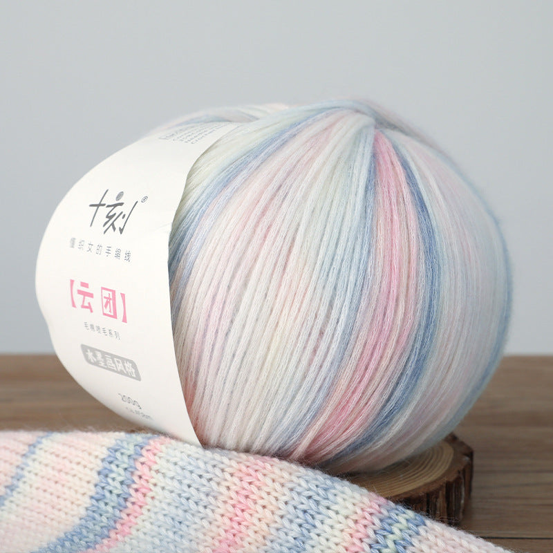 Multicolored yarn ball with a label on a wooden surface