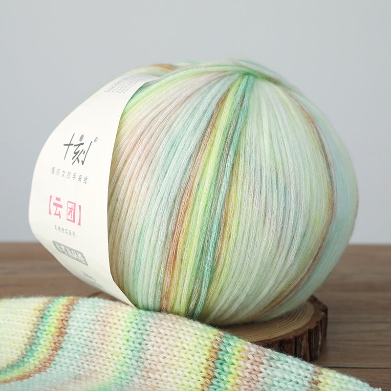 Multicolored yarn ball on a wooden surface with a blurred background