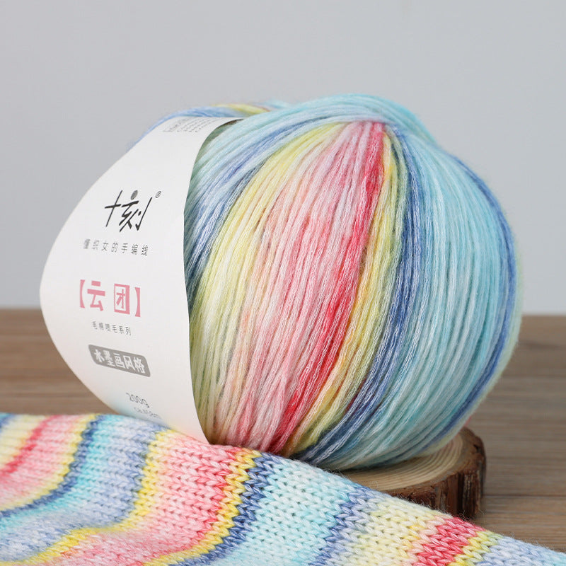 Multicolored yarn ball with a label on a wooden surface