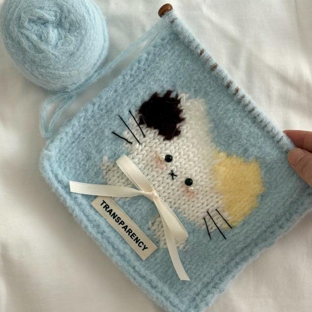 Handmade crochet cat pattern scarf kit with blue yarn, knitting needles and cute kitten design, beginner-friendly crochet kit for cosy winter accessories