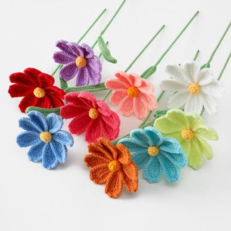 Colorful crocheted gesang flowers on a white background