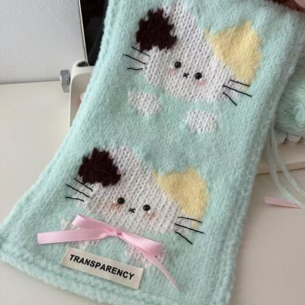 Knitted pouch with cat designs and a pink bow on a light background