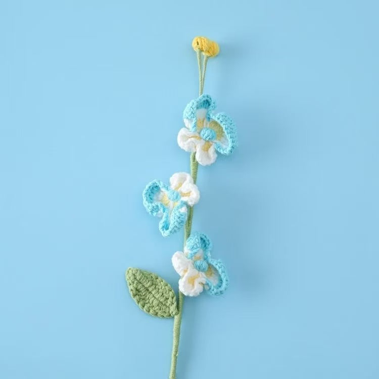 Handcrafted crochet Phalaenopsis orchid flower stem in blue and white, perfect for elegant home décor or a thoughtful handmade gift for her – UK eco-friendly floral craft.
