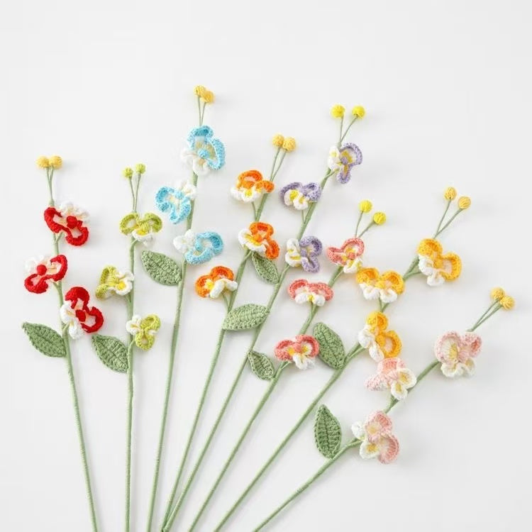 Colorful crocheted Phalaenopsis orchid flowers on a white background