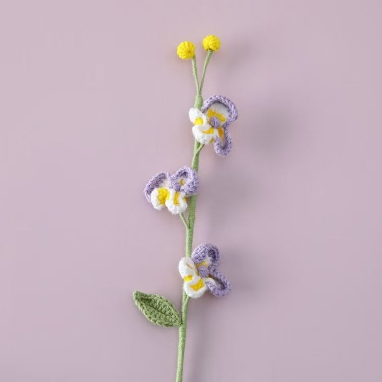 Handcrafted crochet Phalaenopsis orchid flower stem in purple and white, perfect for elegant home décor or a thoughtful handmade gift for her – UK eco-friendly floral craft.