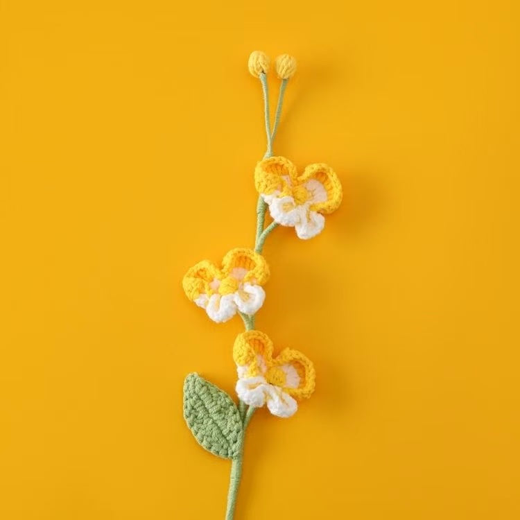 Handcrafted crochet Phalaenopsis orchid flower stem in yellow and white, perfect for elegant home décor or a thoughtful handmade gift for her – UK eco-friendly floral craft.