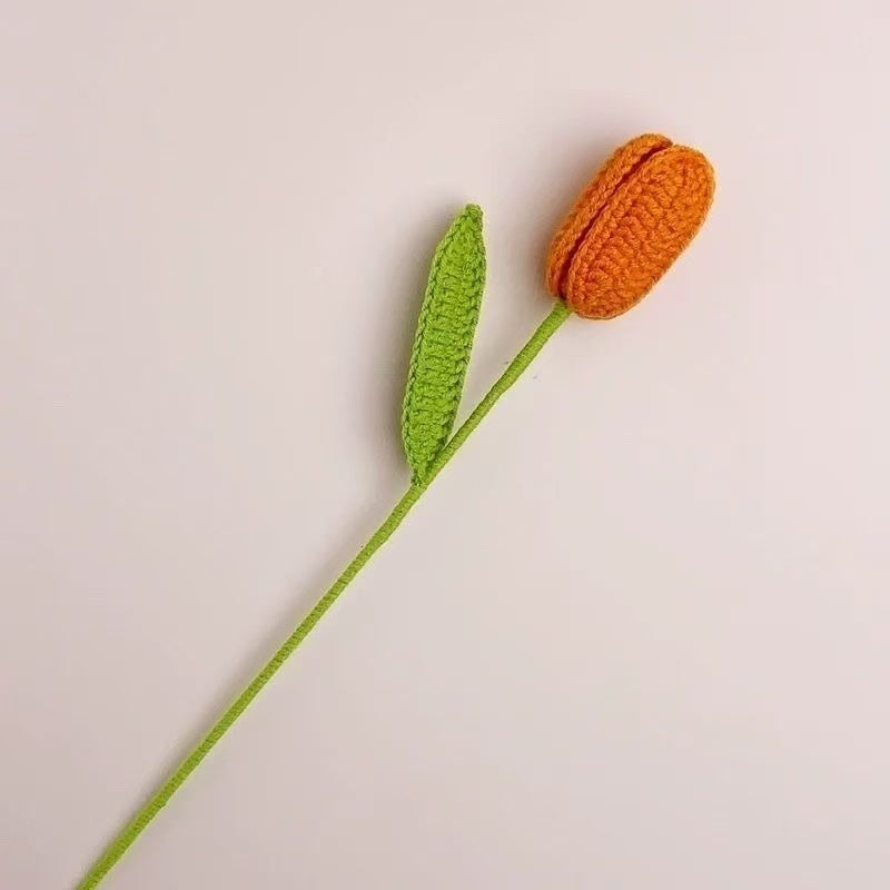 Handmade crochet tulip flower with  orange knitted bud and green stem, decorative artificial crochet flower for home décor or gift