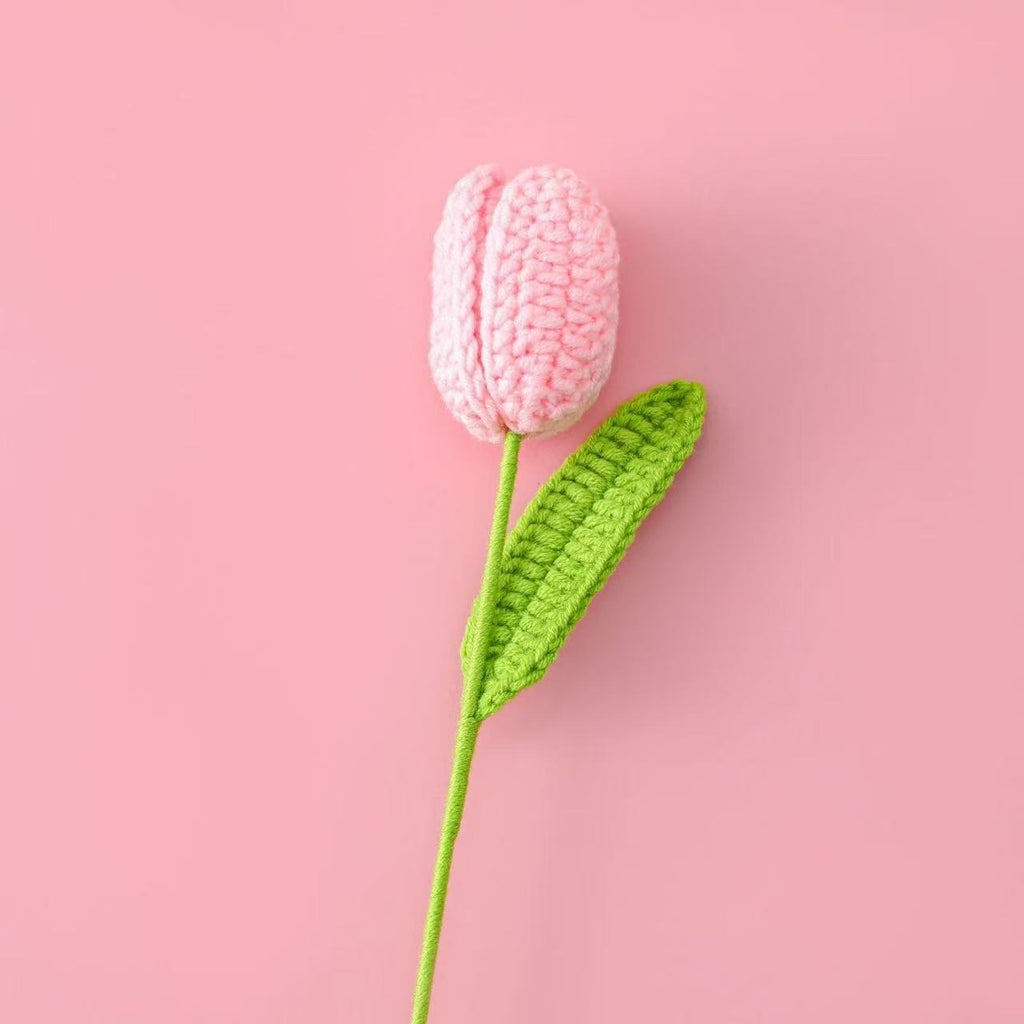 Handmade crochet tulip flower with  pink knitted bud and green stem, decorative artificial crochet flower for home décor or gift