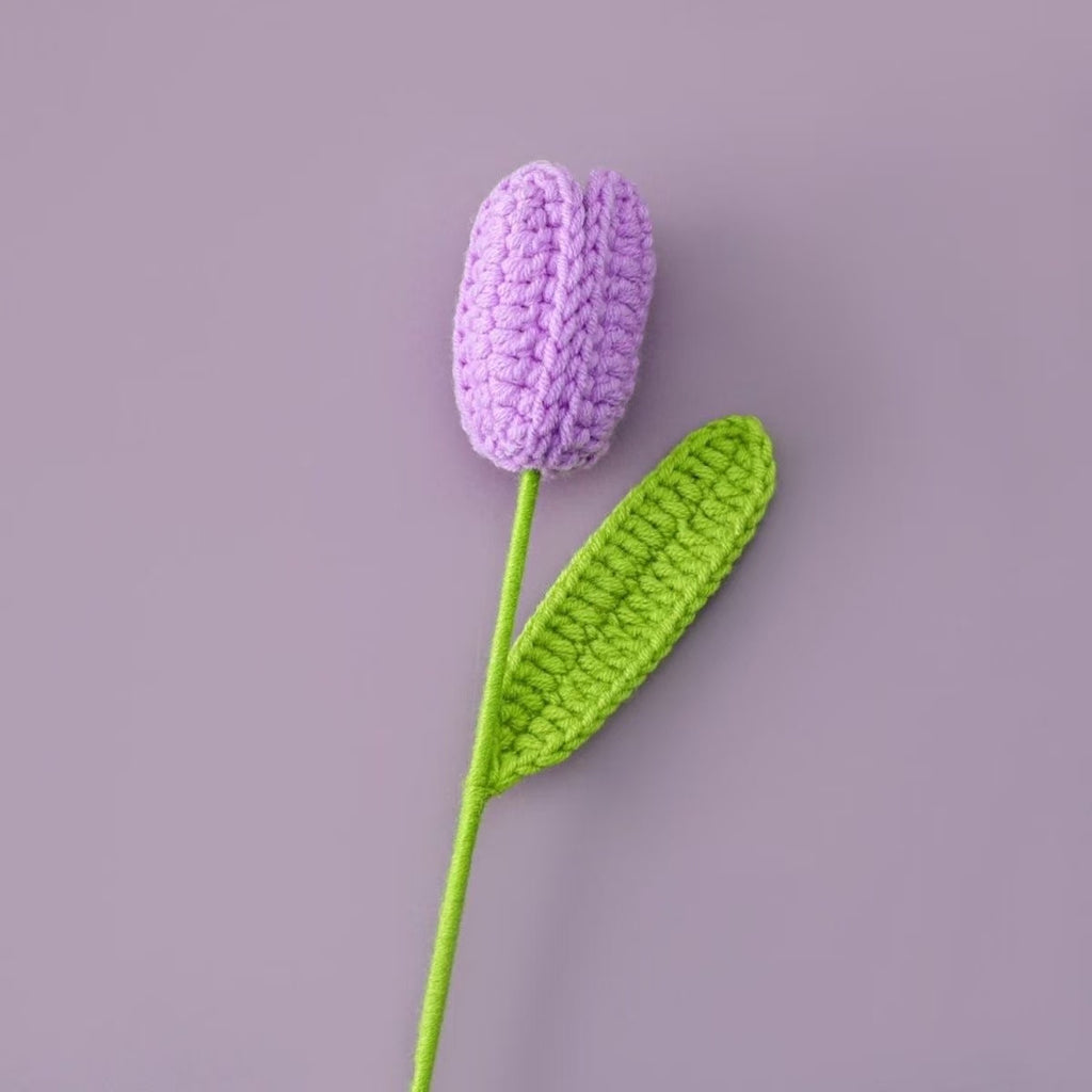 Handmade crochet tulip flower with purple knitted bud and green stem, decorative artificial crochet flower for home décor or gift
