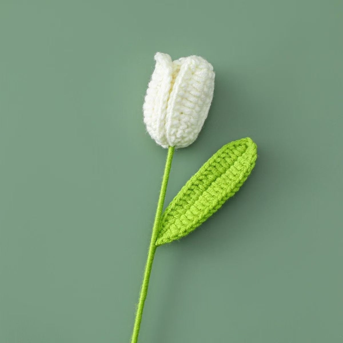 Handmade crochet tulip flower with white knitted bud and green stem, decorative artificial crochet flower for home décor or gift