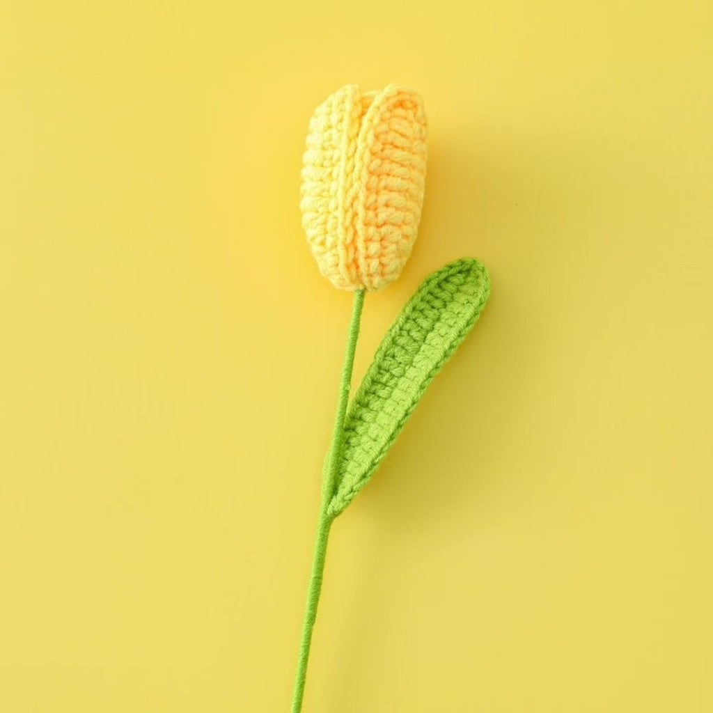 Handmade crochet tulip flower with yellow knitted bud and green stem, decorative artificial crochet flower for home décor or gift
