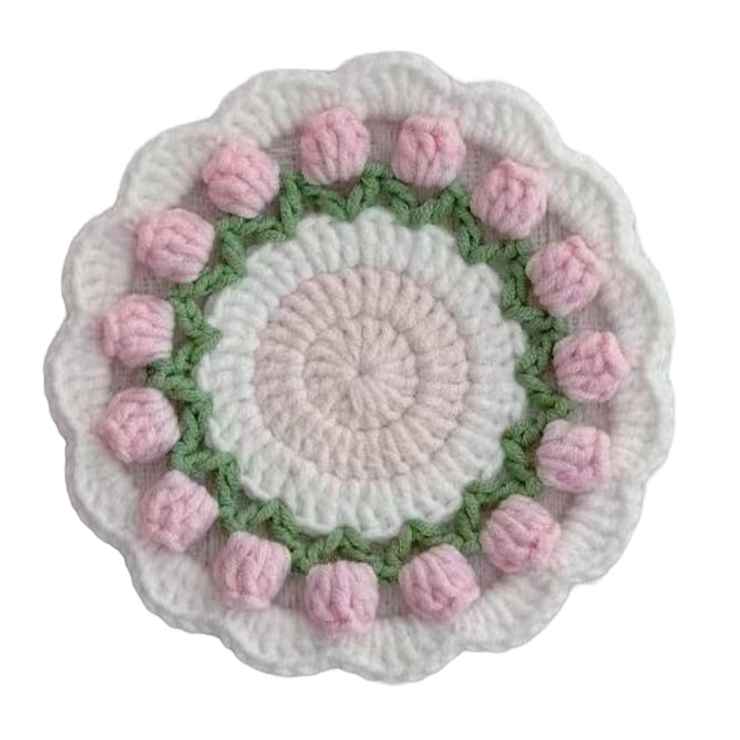 Crocheted coaster with pink flowers on a white background