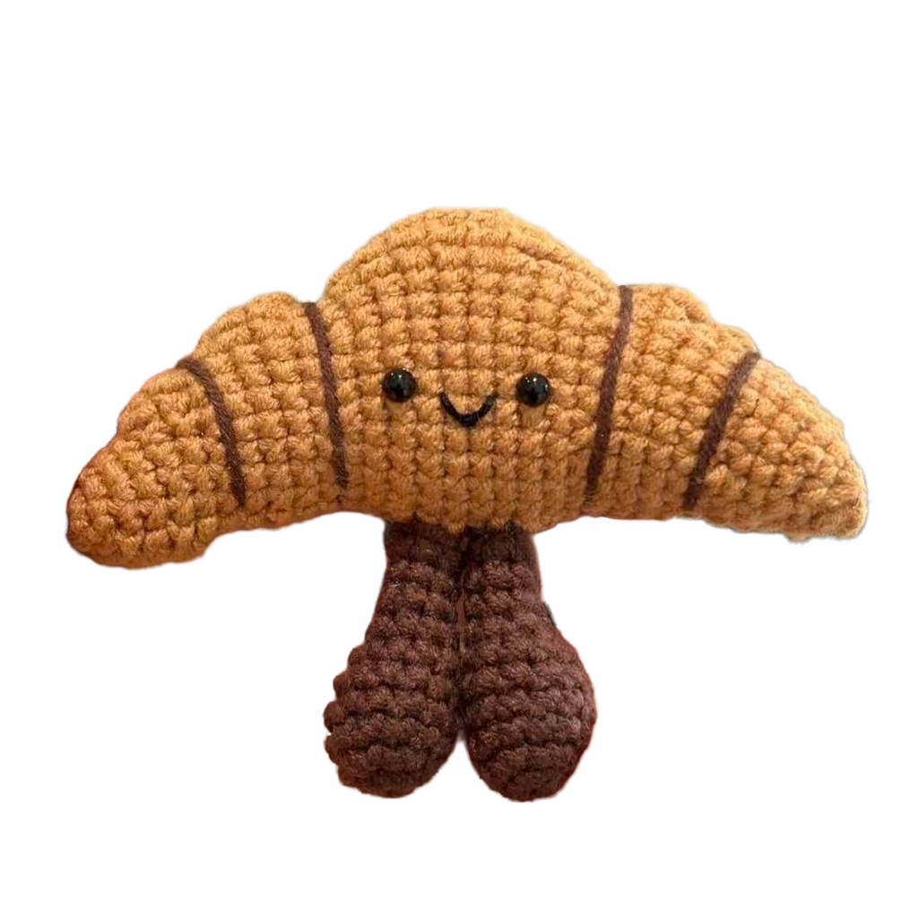 Handmade crochet croissant plush toy with smiling face, soft yarn bakery dessert ornament