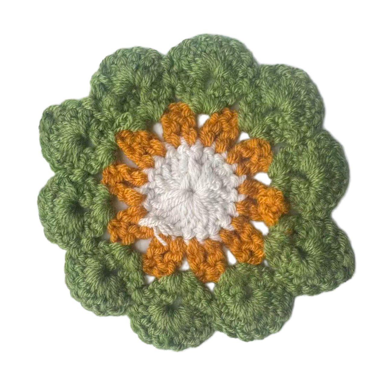 Crocheted flower pattern with green outer petals and orange and white center on a white background