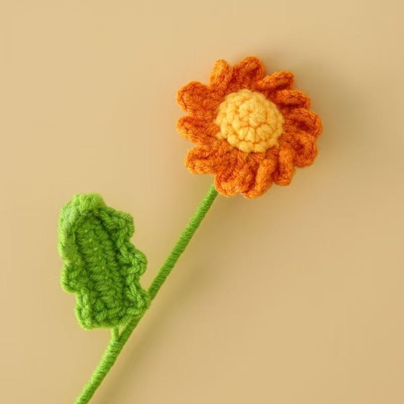 Orange crochet daisy flower with yellow centre and green stem – handmade floral gift for home décor, weddings, or sustainable gifting in the UK