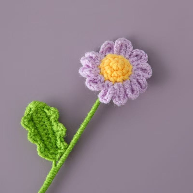Purple crochet daisy flower with yellow centre and green stem – handmade floral gift for home décor, weddings, or sustainable gifting in the UK